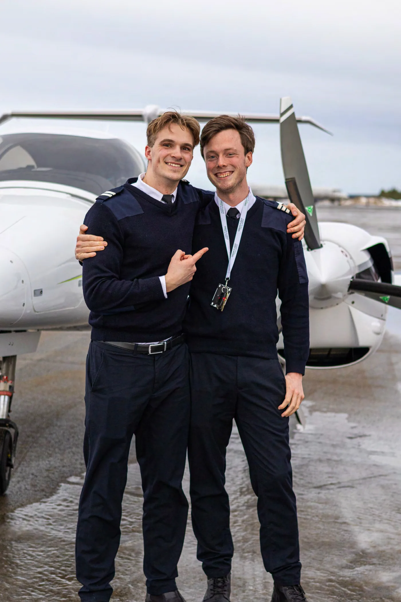 Green Flight Academy pilots beside an aircraft